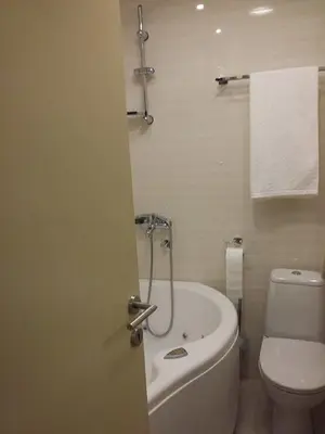 a bathroom with a toilet and a tub and a sink at Lux Life Apartment in Belgrade