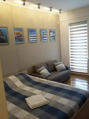 a living room with a couch and a blue couch at Lux Life Apartment in Belgrade