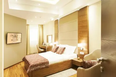 a hotel room with a bed and a desk at NV Luxury Suites & Spa in Belgrade