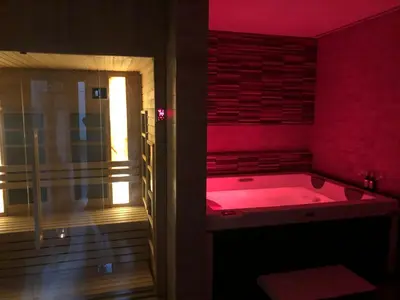 a red bath tub in a room with a window at NV Luxury Suites & Spa in Belgrade