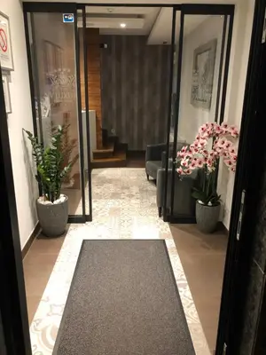 a lobby with two potted plants and a hallway at NV Luxury Suites & Spa in Belgrade