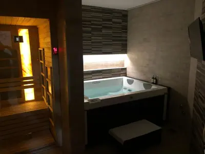 a large bath tub in a bathroom with a window at NV Luxury Suites & Spa in Belgrade