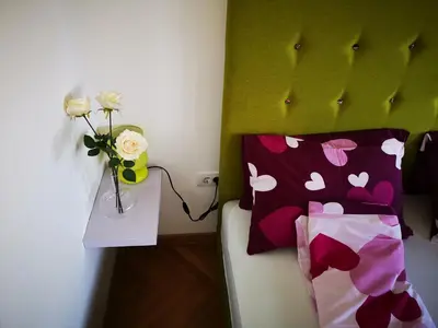 a room with a bed with a vase with flowers on it at Dream Apt with parking in Belgrade