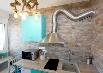 a kitchen with a sink and a stainless steel hood at Dream Apt with parking in Belgrade