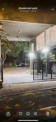 a building with a gate in front of a street at Central City Apartments in Belgrade