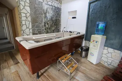 a bathroom with a bath tub and a sink at Marex Centar in Jabuka