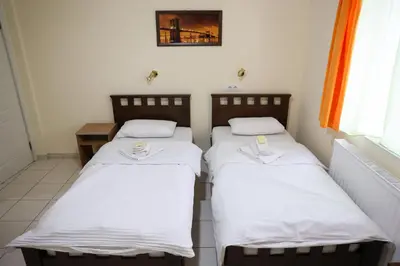 two beds in a room with white sheets at Marex Centar in Jabuka