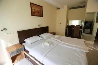 a bedroom with a large bed with white sheets at Marex Centar in Jabuka