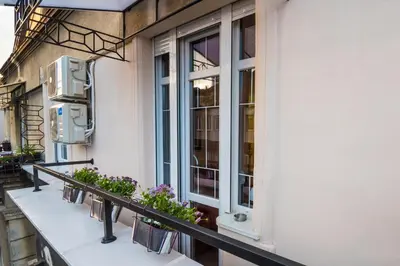 a balcony with potted plants on a building at Bright City Center Apartment with Balcony in Belgrade