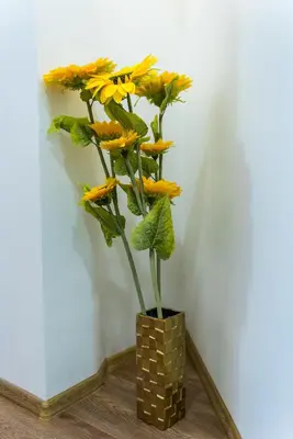 a vase filled with yellow flowers sitting on a table at Bright City Center Apartment with Balcony in Belgrade