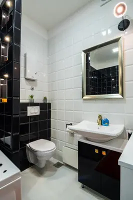 a bathroom with a toilet and a sink and a mirror at Bright City Center Apartment with Balcony in Belgrade