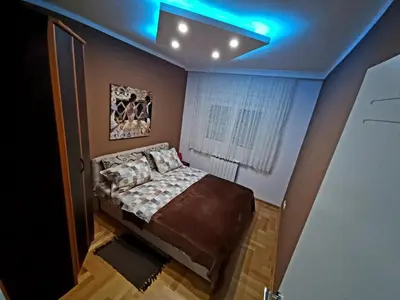 a bedroom with a bed and a blue ceiling at Luxury Apartments Belgrade in Belgrade