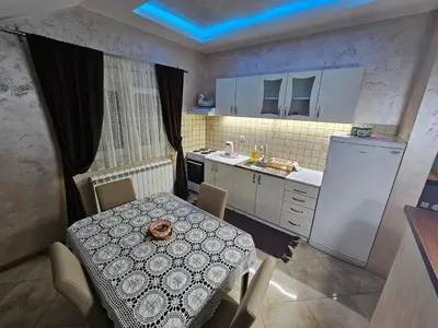 a small kitchen with a table and a sink at Luxury Apartments Belgrade in Belgrade