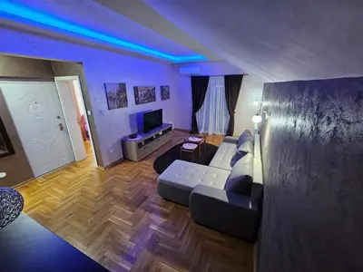 a living room with a couch and a tv at Luxury Apartments Belgrade in Belgrade