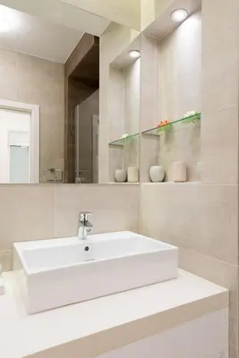 a bathroom with a white sink and a mirror at Vivio Luxury Apartment in Belgrade