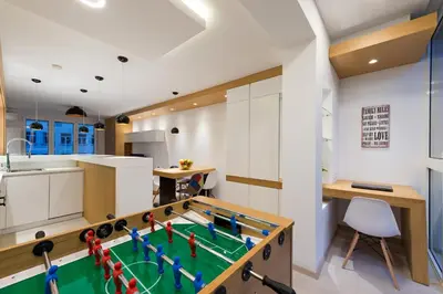 a kitchen with a pool table in the middle of a room at Vivio Luxury Apartment in Belgrade