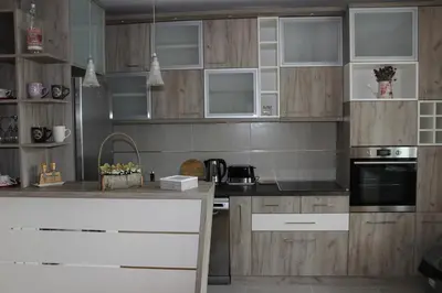 a kitchen with wooden cabinets and a counter top at Orchid House in Belgrade