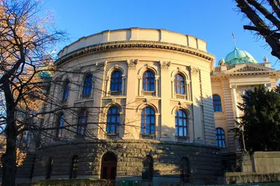 a building with a dome on top of it at Dominic Smart & Luxury Suites - Parliament in Belgrade