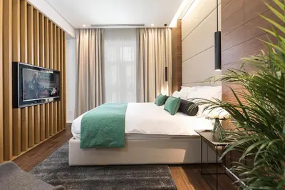 a bedroom with a bed and a tv on a wall at Dominic Smart & Luxury Suites - Parliament in Belgrade