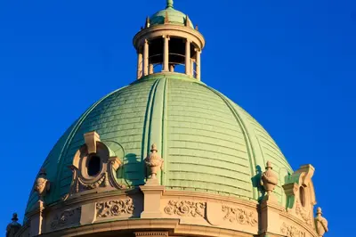 a green roof of a building with a bell tower at Dominic Smart & Luxury Suites - Parliament in Belgrade