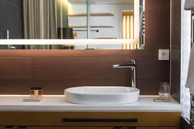 a bathroom with a sink and a mirror at Dominic Smart & Luxury Suites - Parliament in Belgrade