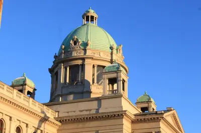 a building with a green dome on top of it at Dominic Smart & Luxury Suites - Parliament in Belgrade