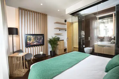 a bedroom with a large bed and a bathroom at Dominic Smart & Luxury Suites - Parliament in Belgrade