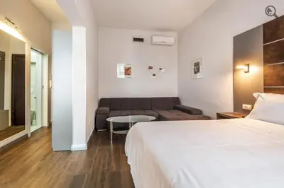 a hotel room with a bed and a couch at Passion Downtown Suite in Belgrade