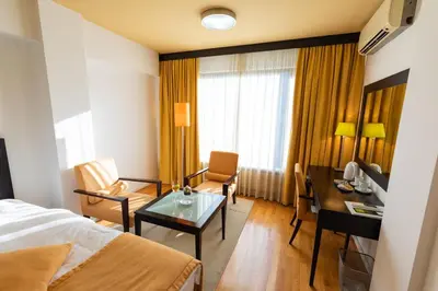 a hotel room with a bed and a desk at Hotel M in Belgrade