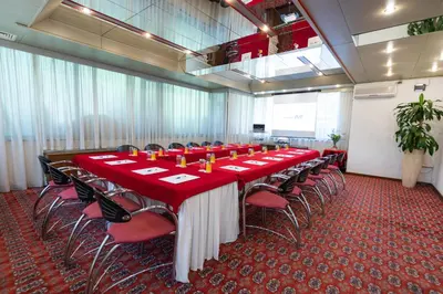 a conference room with a long table and chairs at Hotel M in Belgrade