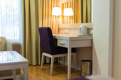 a room with a desk with a chair and a mirror at Hotel M in Belgrade