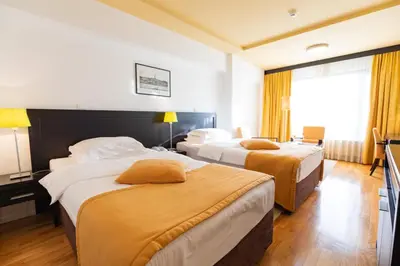 a hotel room with two beds and a window at Hotel M in Belgrade