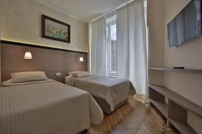 a hotel room with two beds and a window at Apartment Alek in Belgrade