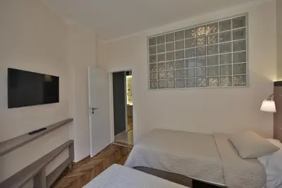 a bedroom with a bed and a flat screen tv at Apartment Alek in Belgrade