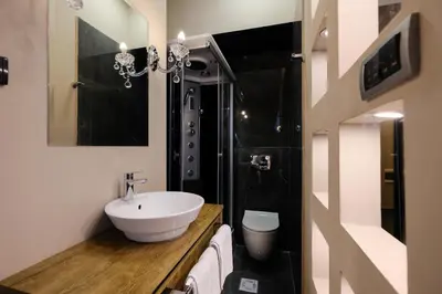 a bathroom with a sink and a shower at Ben Akiba Luxury Suites in Belgrade