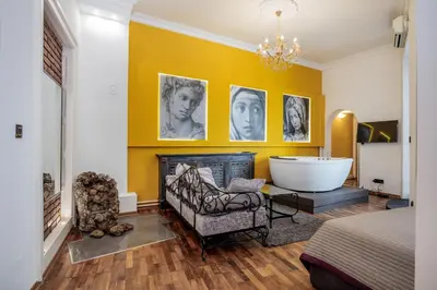 a bedroom with a bathroom with a tub and a bed at Ben Akiba Luxury Suites in Belgrade
