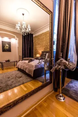 a bedroom with a bed and a large mirror at Ben Akiba Luxury Suites in Belgrade