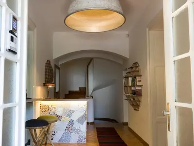 a hallway with a kitchen with a large ceiling at Balkan Soul Hostel in Belgrade