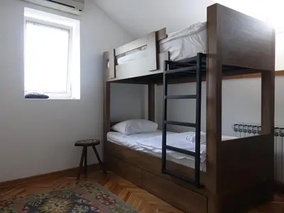 a bunk bed room with a bunk bed with a bed sidx sidx sidx at Balkan Soul Hostel in Belgrade