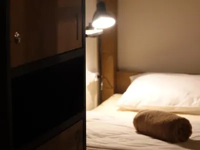 a bedroom with a bed with a pillow on it at Balkan Soul Hostel in Belgrade