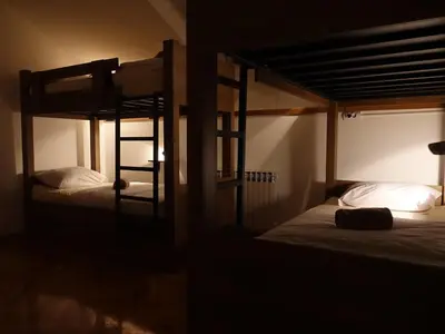 two bunk beds in a dark room at Balkan Soul Hostel in Belgrade