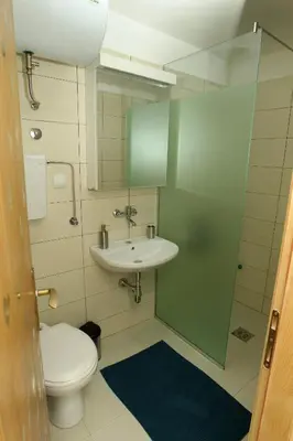 a bathroom with a toilet and a sink at Blue Box Apartment in Belgrade