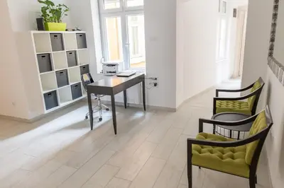 an office with a desk and chairs in a room at Apartment Savamala 59 in Belgrade