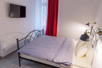 a bedroom with a bed and a red curtain at Apartment Savamala 59 in Belgrade