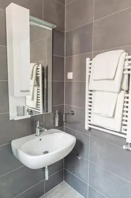 a bathroom with a sink and a mirror and towels at Apartment Savamala 59 in Belgrade