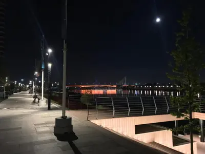 a boardwalk at night with a pier and lights at Apartment Savamala 59 in Belgrade