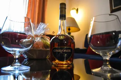 a bottle of wine next to two glasses on a table at Palace Hotel in Belgrade