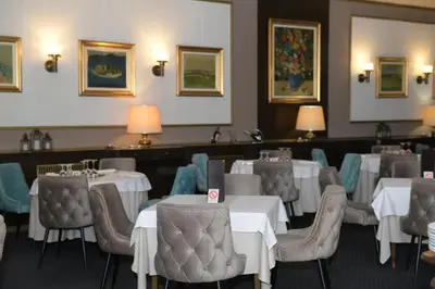 a dining room with white tables and chairs at Palace Hotel in Belgrade