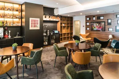 a restaurant with tables and chairs and a bar at Best Western Premier Natalija Residence in Belgrade