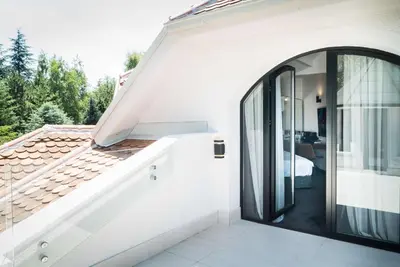 a white house with a large glass door at Best Western Premier Natalija Residence in Belgrade